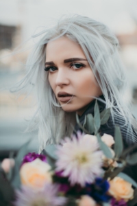 woman gray hair holding flowers